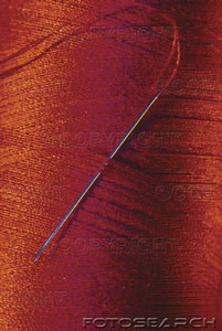 [close-up-of-red-spool-of-thread-and-needle-~-ks2543.jpg]