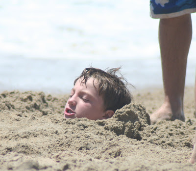 buried in the sand at the beach