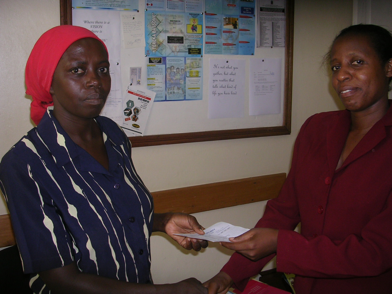 [Jennifer+Namumbya+(r)+presents+loan+paymnet+receipt+to+Rose+Kasoma.JPG]