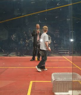 Alan Thatcher on court with a young member of the audience during the build-up
