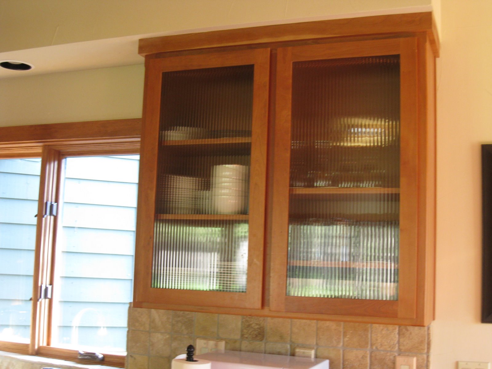 Kitchen Cabinet Door Glass Inserts on Upper Kitchen Cabinets Feature Reed Glass Wood Framed Doors   Above