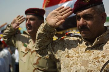 Members of the Iraqi army salute while the Iraqi national anthem plays during the Najaf International Airport inauguration ceremony, July 20.