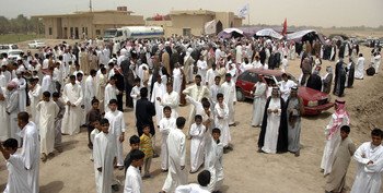 More than 500 sheiks mingle outside a tent during an annual meeting to discuss issues concerning their tribes and upcoming elections in Samawa, July 16.