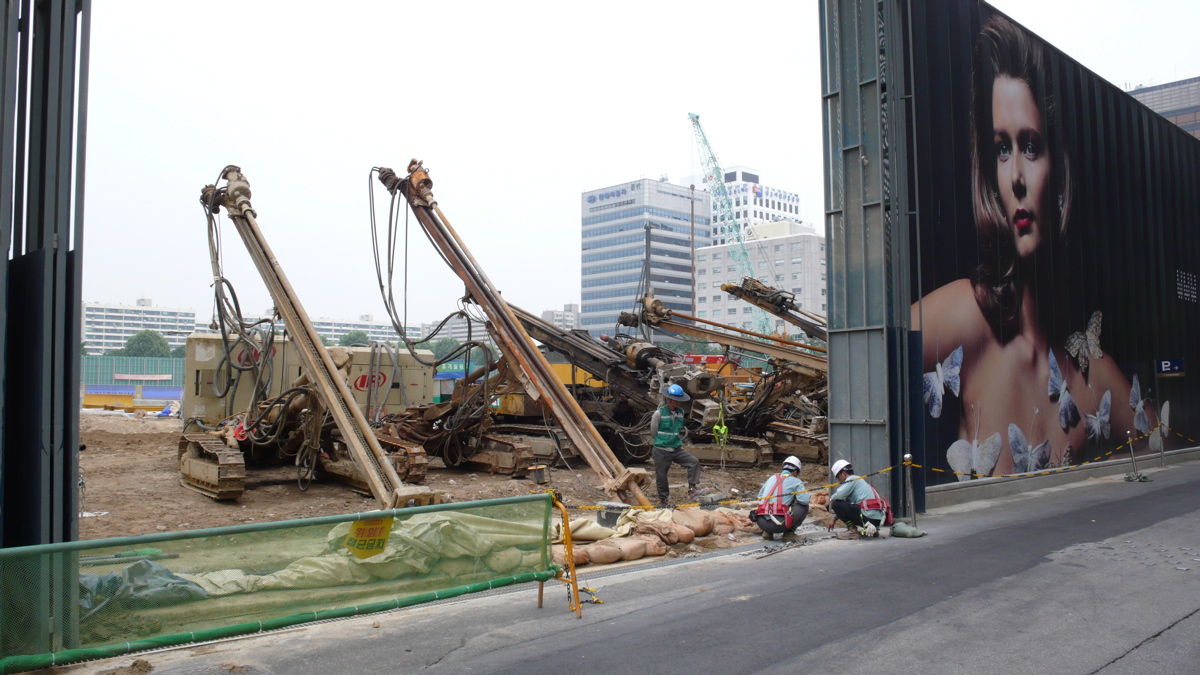IFC Seoul construction site, with hoardings and drilling machines