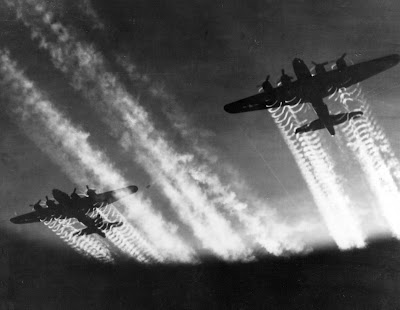 Two B-17 Flying Fortresses' vapor trails light up the night sky over Eastern 