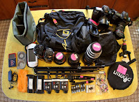 a table with a bag and camera equipment