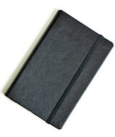 a black notebook with a strap