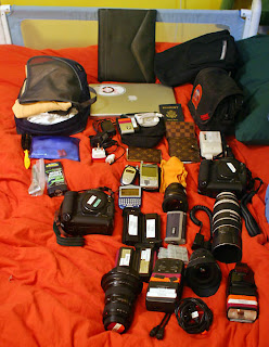 a group of camera equipment on a bed