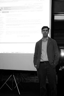 a man standing in front of a projector screen
