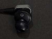 a black earbuds on a black surface