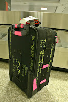 a black suitcase with writing on it