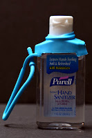 a hand sanitizer bottle with a blue handle
