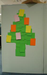Homemade Christmas Tree - a DIY affair using coloured cards stuck with blutac to the back of a filing cabinet