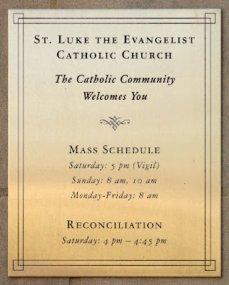 Saint Luke the Evangelist Church, in Richmond Heights, Missouri - sign with Mass times