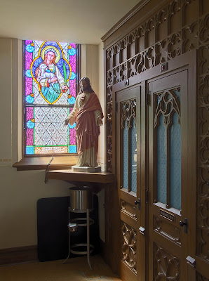 Immaculate Conception Roman Catholic Church, in Augusta, Missouri, USA - stained glass window of Saint Agnes; statue of Sacred Heart of Jesus; confessional