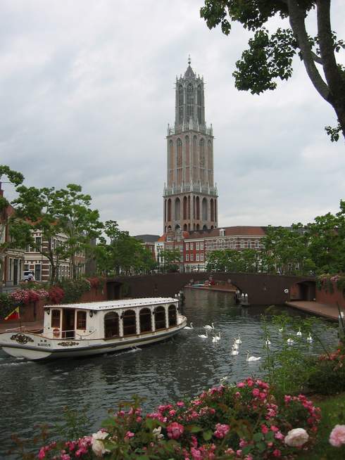 Canal with boat and Tower in the background