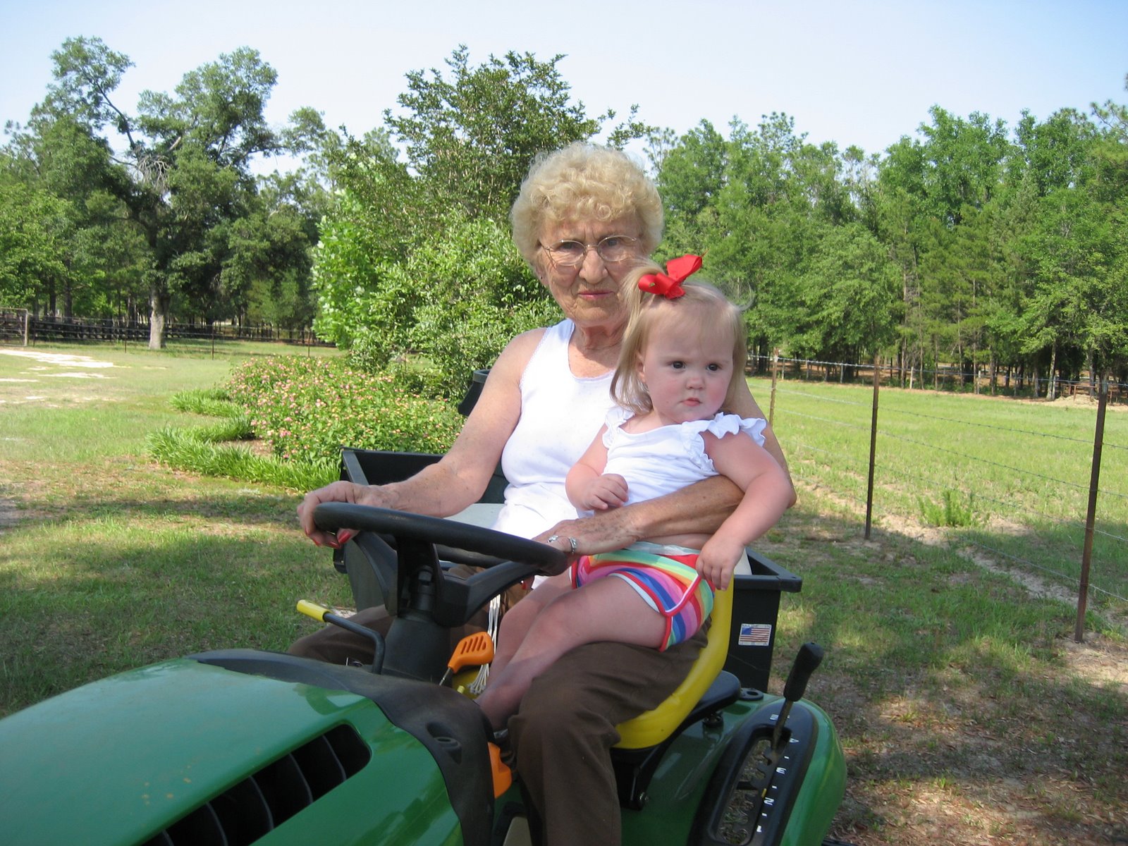 [mawmaw+and+vivian+on+the+tractor.JPG]