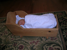 Tyler Sleeping in a doll cradle