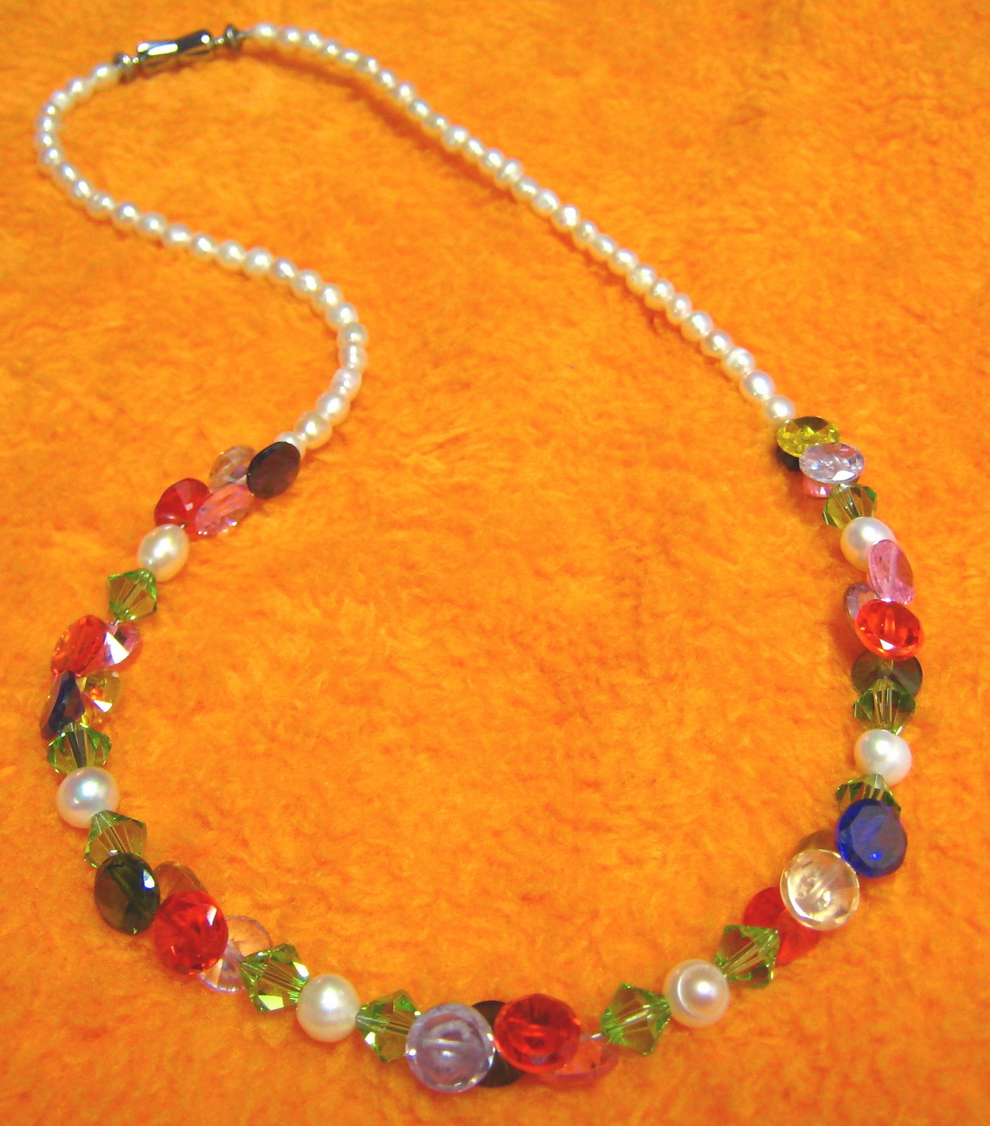 stringed piece of necklace of crystal and pearl