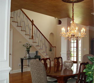 Formal Dining Room with crystal chandelier, wainscotting, and aritst faux paint ceiling