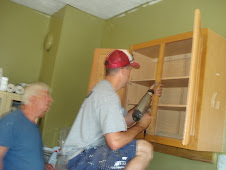 Shawn &  Frank are installing cabinets.