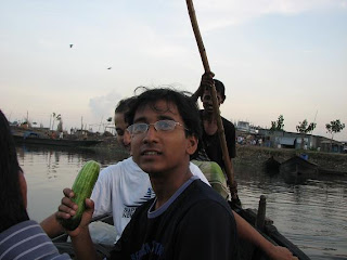 We are crossing the lake by boat. Jashim is holding salad item