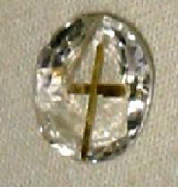 White sapphire with inside golden holy cross