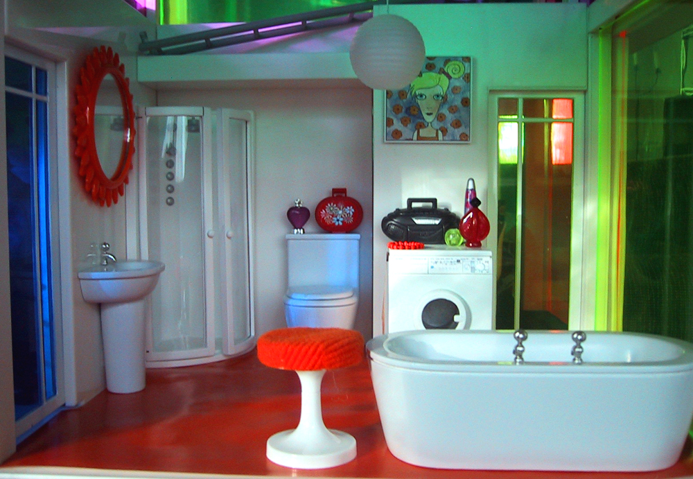 Modern miniature dolls' house bathroom in orange and white.