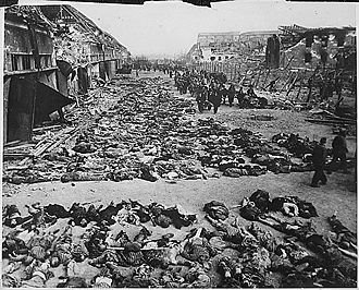 [330px_Rows_of_bodies_of_dead_inmates_fill_the_yard_of_Lager_Nordhausen_2C_a_Gestapo_concentration_camp.jpg]