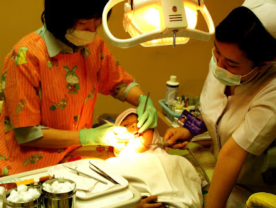 A Dentist, Patient and Dental Assistant