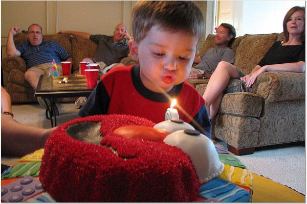 [051207-andrew+blowing+out+candle.jpg]