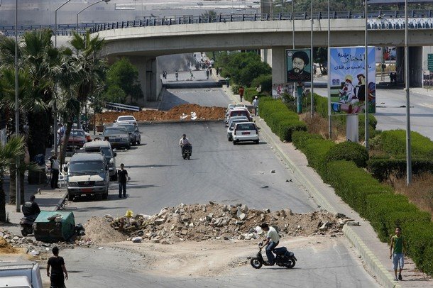 [Lebanese+ride+their+motorcycles+around+mounds+of+earth+blocking+the+main+road+leading+to+Rafiq+Hariri+International+Airport+in+Beirut+on+May+8,+2008.jpg]