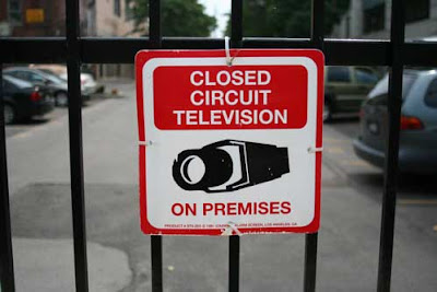 Closed circuit television on premises warning sign on a fence