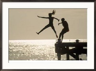 [Silhouette-of-Girls-Jumping-off-Pier-Framed-Photographic-Print-C12768405.jpg]