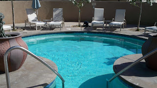 a pool with a ladder and chairs