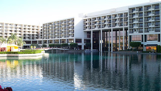 a large building with a pool in front