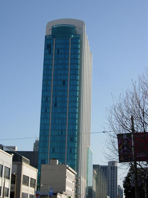 a tall building with blue glass windows