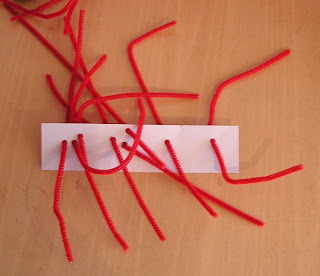 Fine motor skills practice with pipe cleaner threading