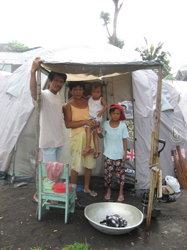 [Maninang-family-in-front-of-their-house-tent-in-DSWD-Region-5---Bagumbayan-Elementary-School-Evacuation-Center,-Daraga,-Albay.jpg]