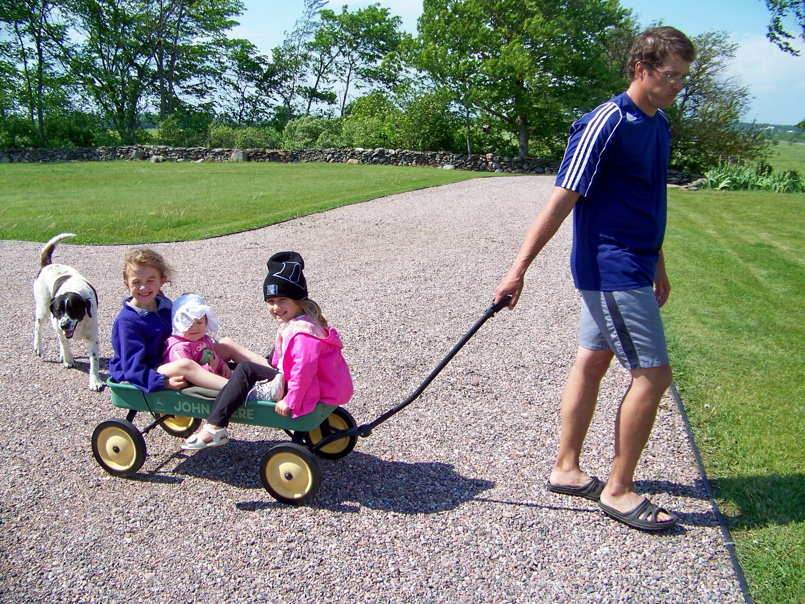 [dad+pulling+kids+in+wagon.jpg]
