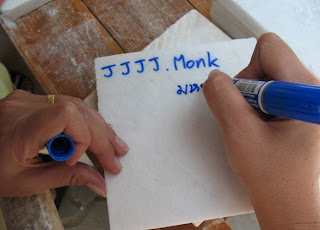 Writing our family names on a marble tile to be used in the building of the Big Buddha in Phuket