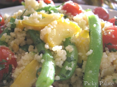 Close up of couscous tossed with garden vegetables.